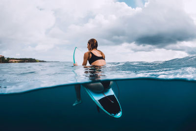 Young woman swimming in sea