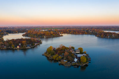 High angle view of river and cityscape against sky during sunset