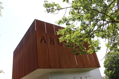 Low angle view of text on building against sky