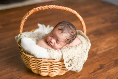 High angle view of cute baby in basket