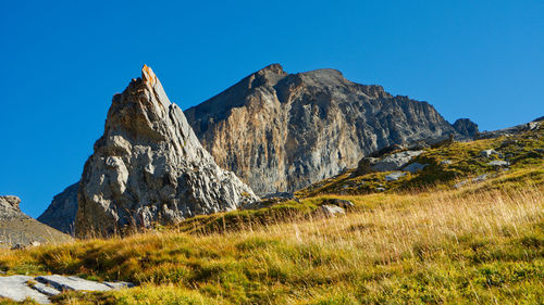 Scenic view of rocky mountains against clear blue sky