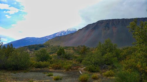 Scenic view of mountains against cloudy sky
