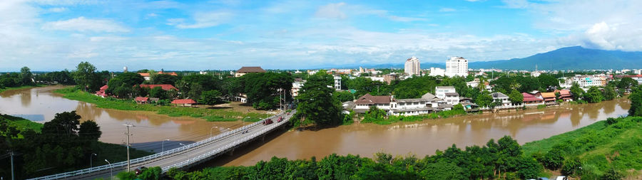 Panoramic view of river and buildings against sky