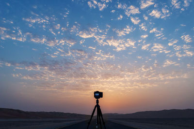 Camera against sky during sunset
