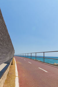 Scenic view of beach against clear blue sky