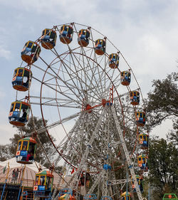 Low angle view of ferris wheel against sky