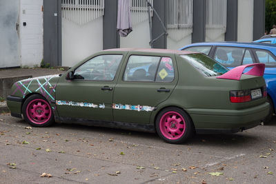 Vintage car parked on street against buildings