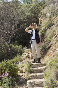 Full length of man standing on tree