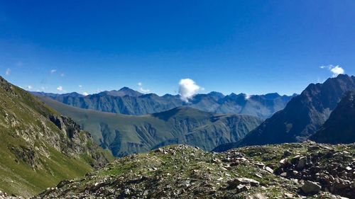 Scenic view of mountains against blue sky