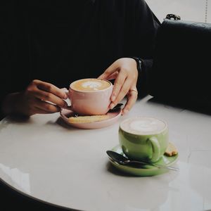 Midsection of coffee cup on table