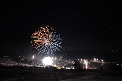 Firework display in sky at night