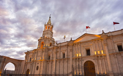 Low angle view of historical building against cloudy sky