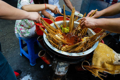 Midsection of people holding food