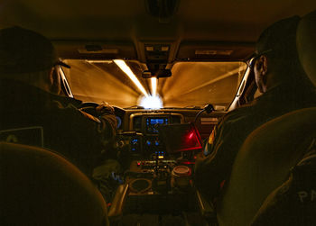 Rear view of men sitting in ambulance