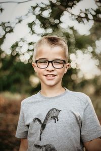 Portrait of boy wearing eyeglasses outdoors