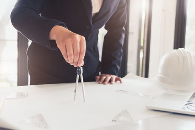 Midsection of woman working on table