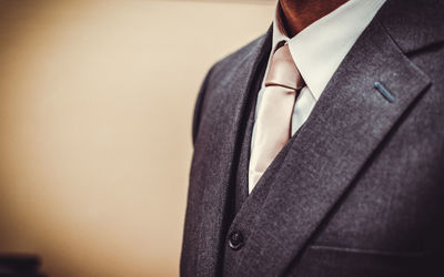 Midsection of man in suit