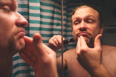 Portrait of handsome young man in bathroom