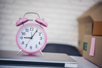 Close-up of clock on table at home