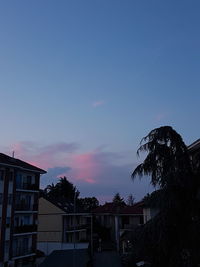 Low angle view of buildings against sky at sunset