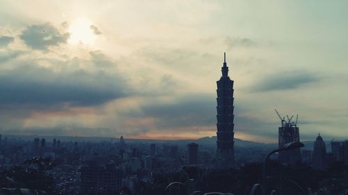 Cityscape against cloudy sky
