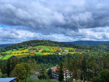 Scenic view of trees and buildings against sky