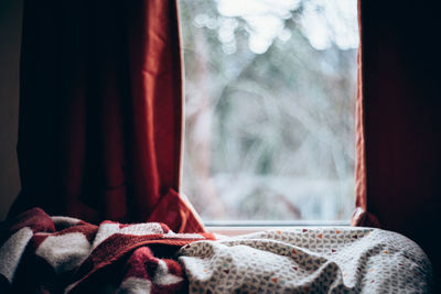 Close-up of curtain on bed at home