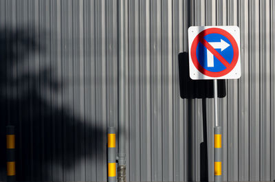 Close-up of arrow sign on road