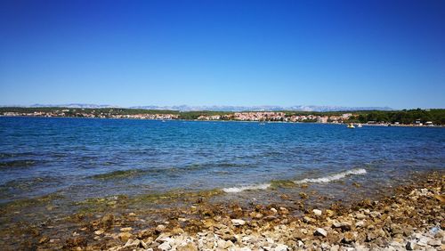 Scenic view of sea against clear blue sky