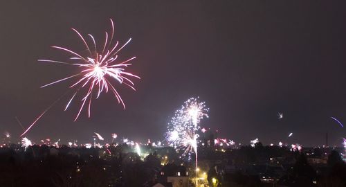 Low angle view of firework display against sky at night