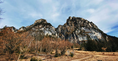 Low angle view of rocks on mountain against sky