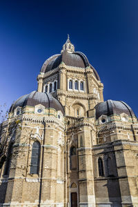 Low angle view of historical building against clear blue sky