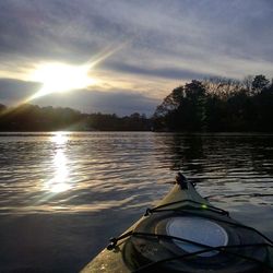 Scenic view of river against sky at sunset