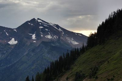 Scenic view of mountain range against cloudy sky