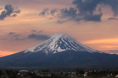 Scenic view of snowcapped mountains against sky during sunset