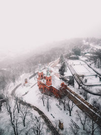 High angle view of snow covered field against sky