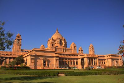 Low angle view of building against clear blue sky