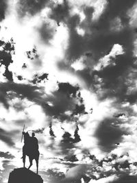 Low angle view of silhouette dog against sky