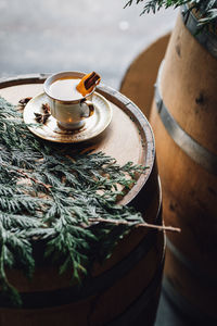 Hot toddy tea cup on whiskey barrel with greenery