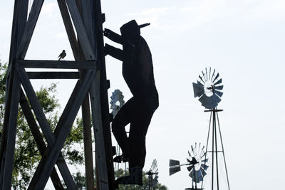 Low angle view of silhouette man against sky