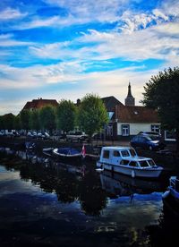 Boats in river with buildings in background