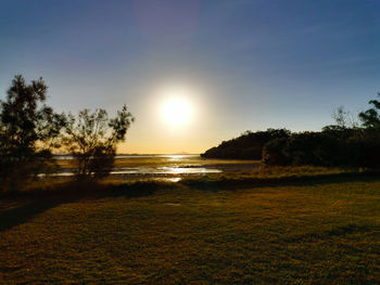 Scenic view of field against sky during sunset