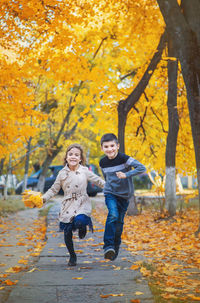 Portrait of happy friends standing on field