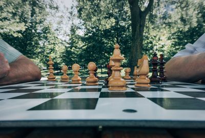 Cropped image of friends playing chess