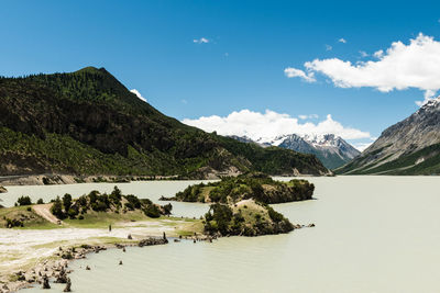 High angle view of river through mountains against cloudy sky