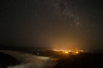 Aerial view of illuminated city against sky at night