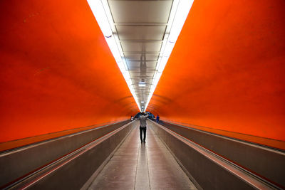 Rear view of man on illuminated subway