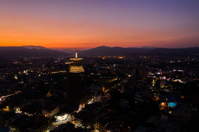 High angle view of illuminated buildings in city at night