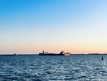 Scenic view of sea against clear sky during sunset
