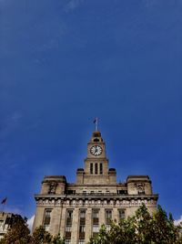 Low angle view of building against blue sky